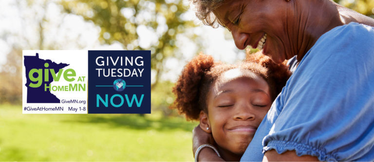 close up photo of an African American girl smiling in the arms of her grandmother