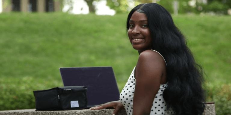 photo of Alaysha sitting outside at a picnic table