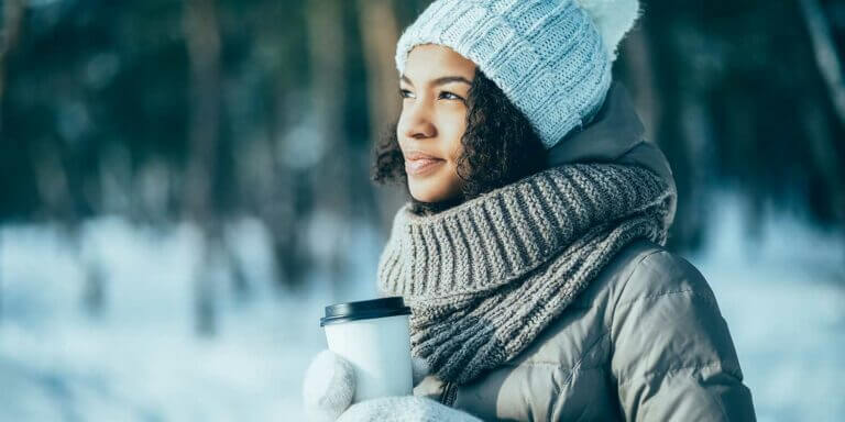 African American young woman enjoying sunny winter day alone