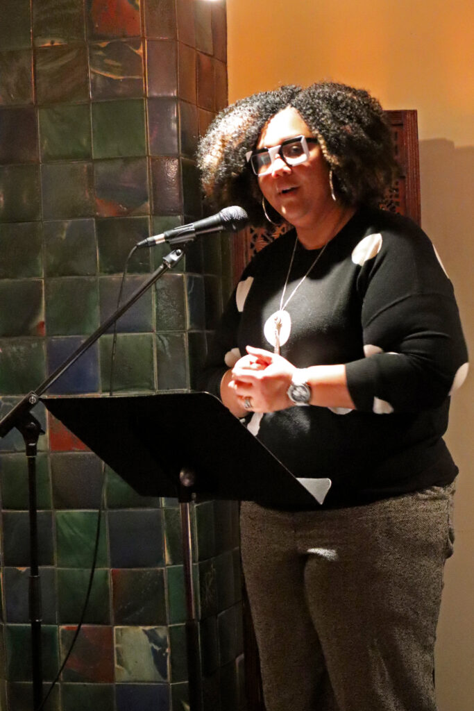 YWCA St. Paul CEO Ashley Booker standing at a microphone giving a speech